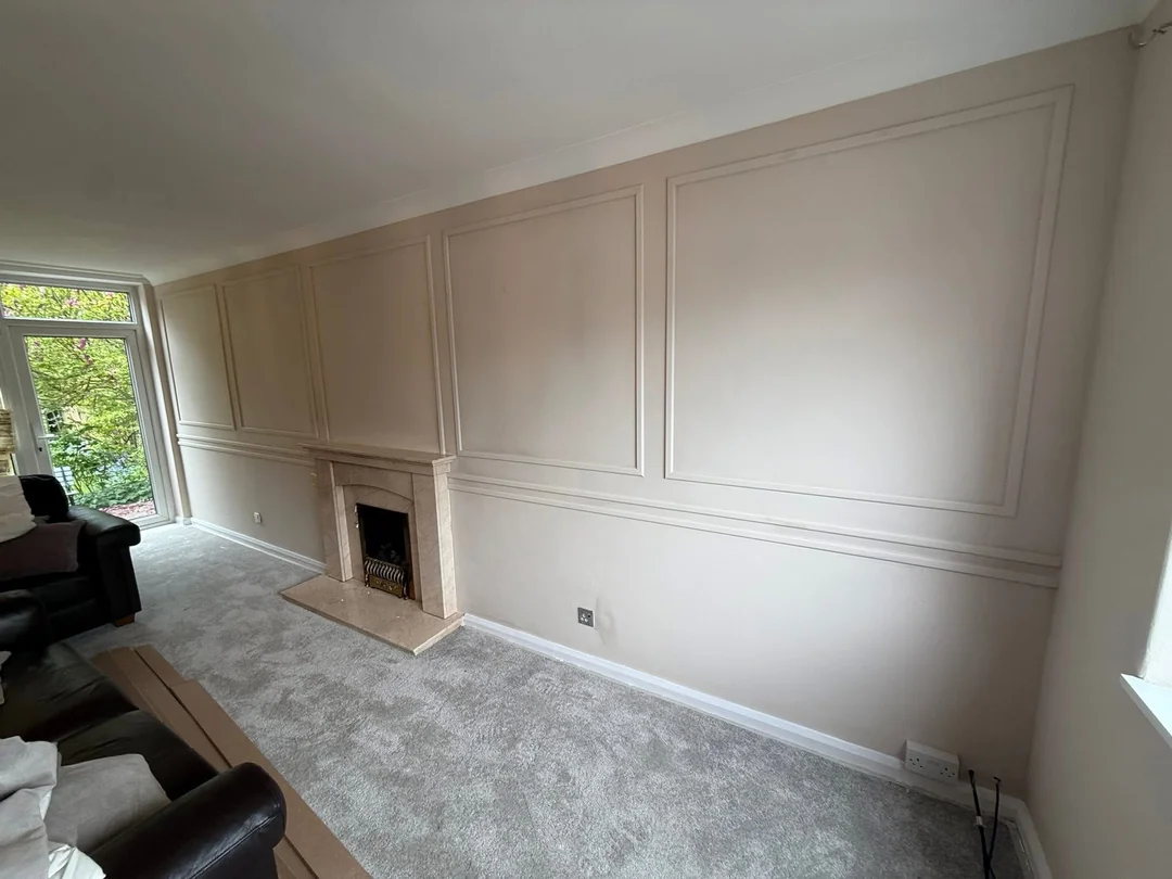 Living-room wall mouldings and fireplace surround after decorating