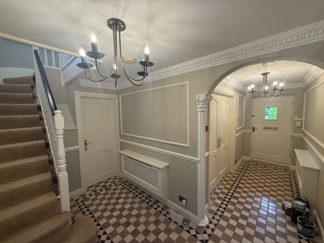 Completed Whitegate hallway with decorative mouldings and staircase