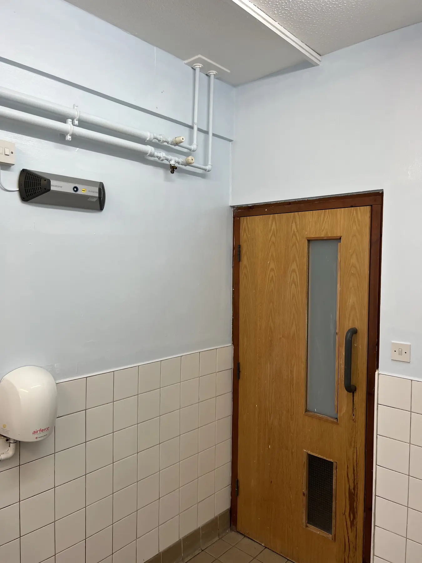 Completed school bathroom wall around timber door