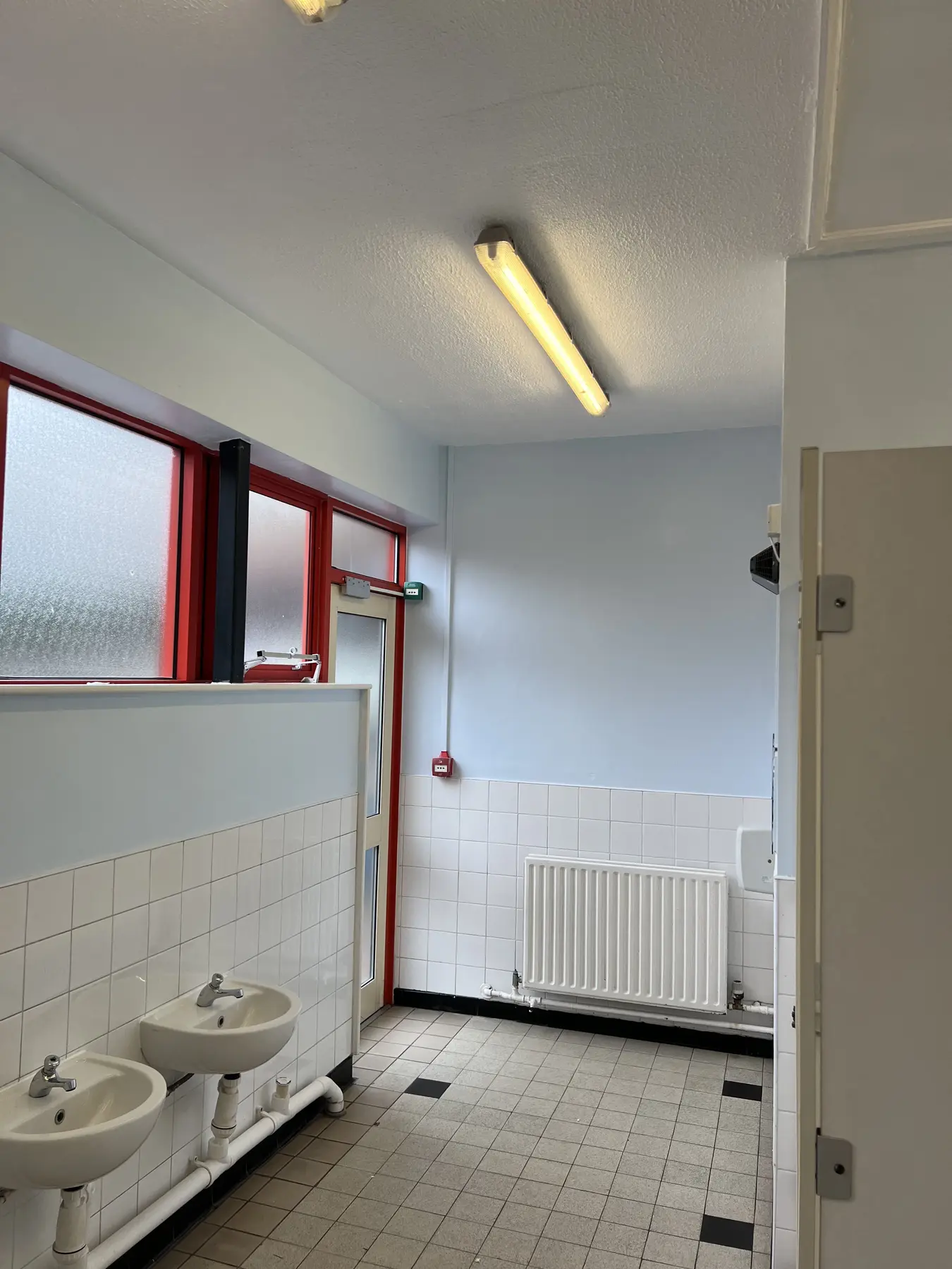 Completed light-blue school bathroom wall at Darnhall