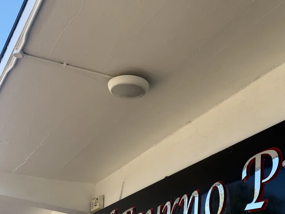 Shopfront canopy soffit around the light fitting after redecoration.
