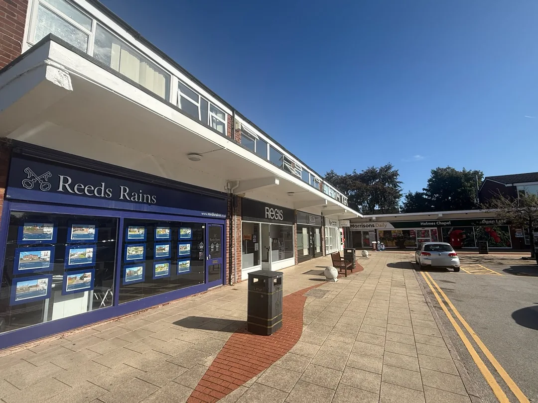 Decorated shopfront canopy along the opposite side of Holmes Chapel Shopping Precinct.