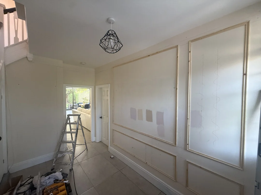 During decorating: fitted wall beading and paint samples before the finished paint and wallpaper scheme.
