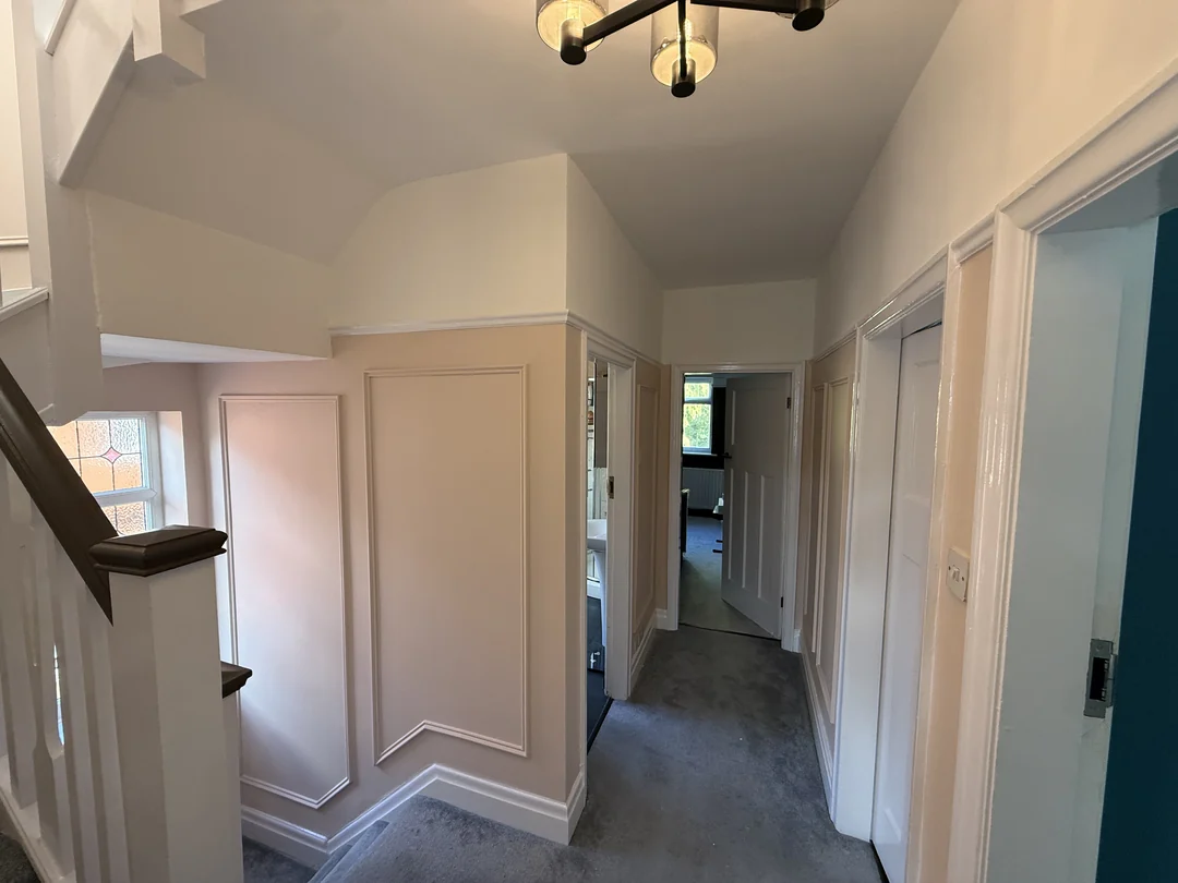 The finished landing, with beading around the wall sections beside the staircase.