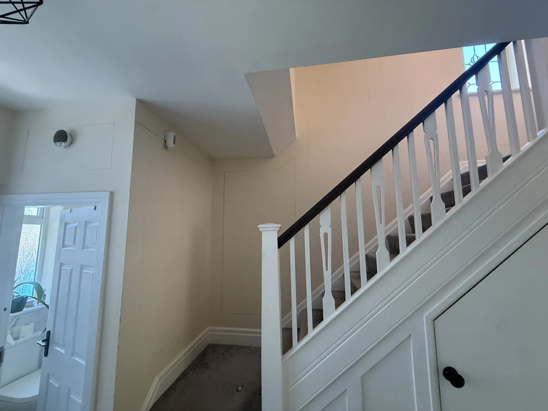 The entrance hall and staircase before the wall treatment.