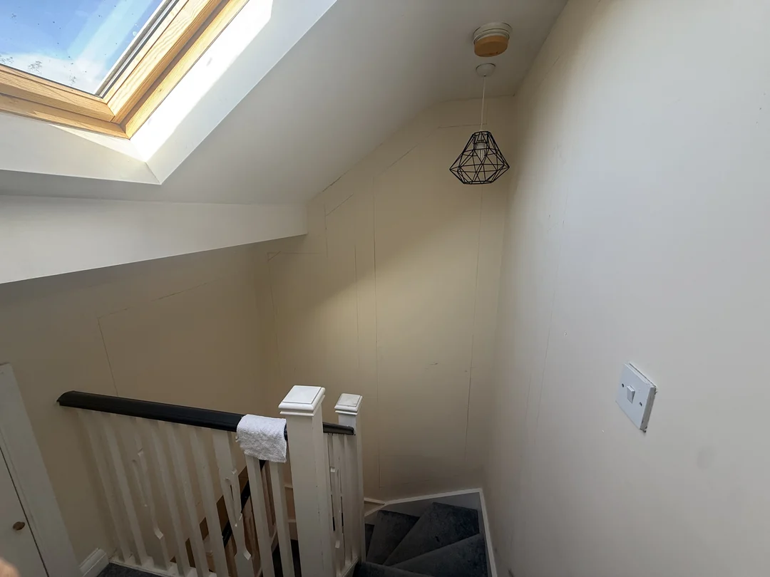 The upper landing wall beside the balustrade before decorating.