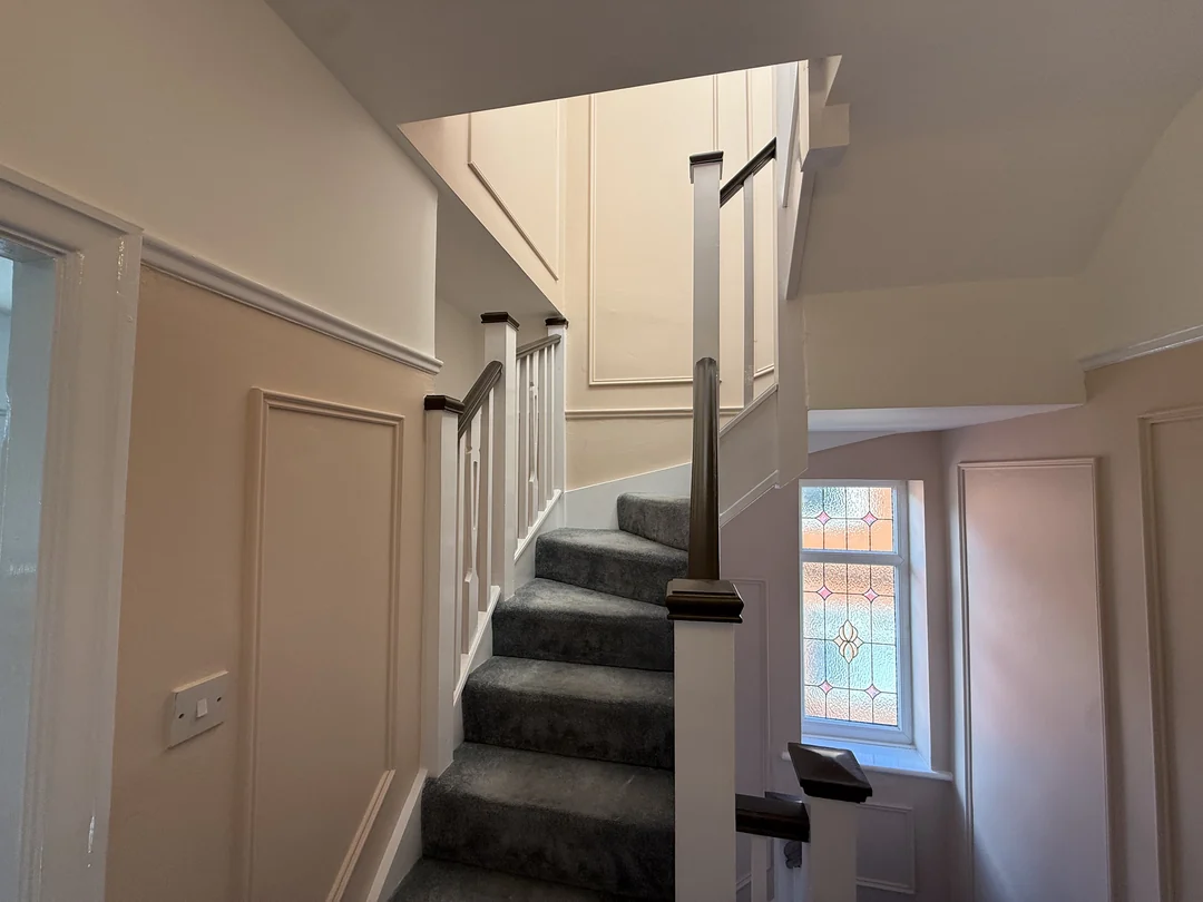 Painted wall beading and door surrounds along the landing.