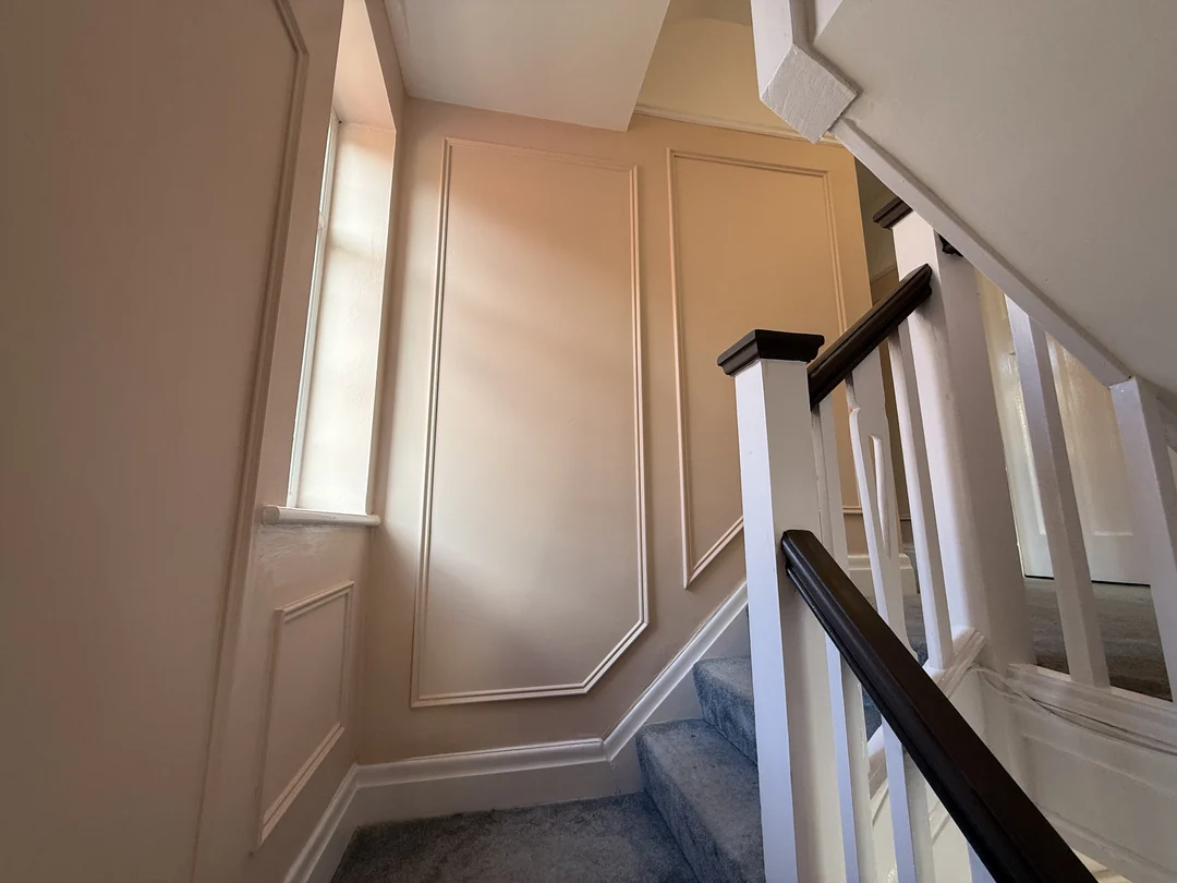 The completed wall panels beside the stairwell window.