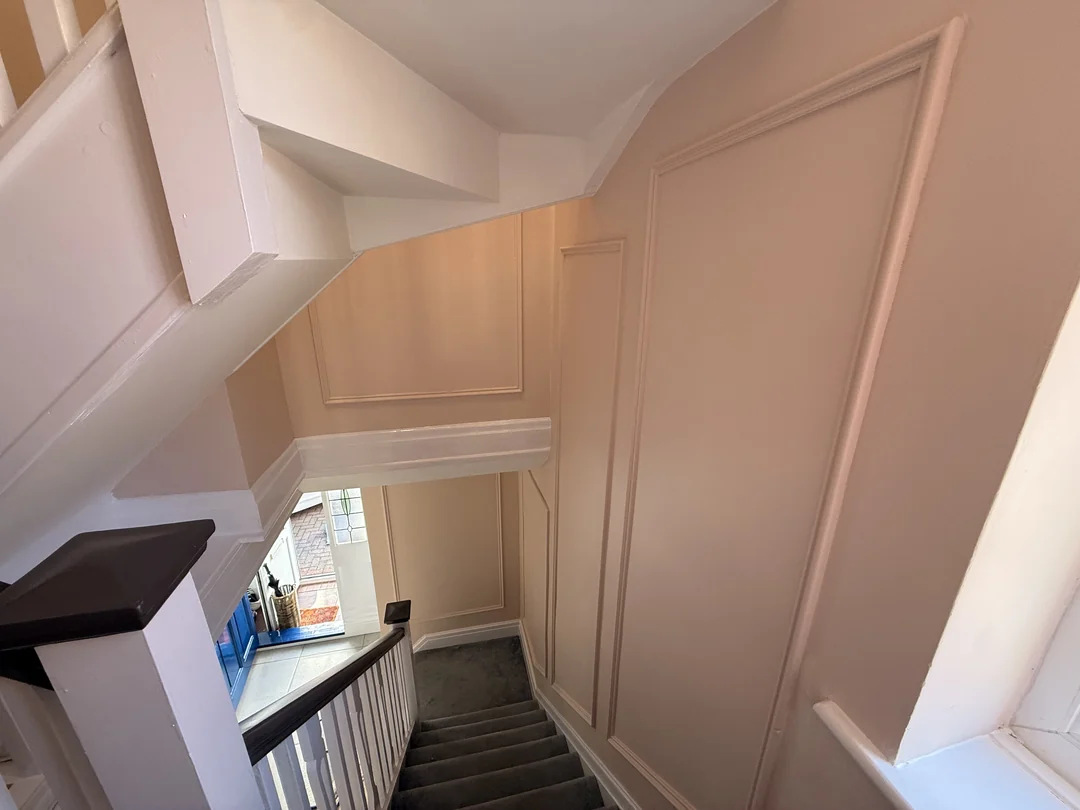 The completed beaded stairwell wall, looking down beside the window.