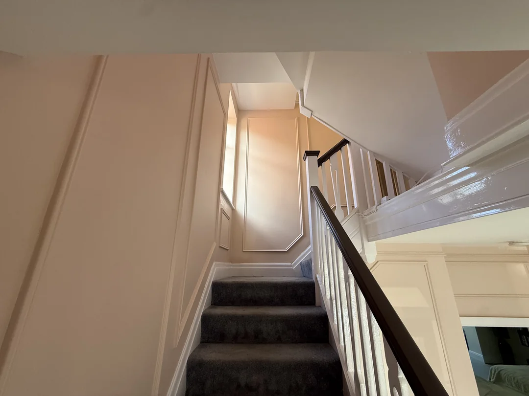 The same stairwell after beading and painting, looking towards the window.