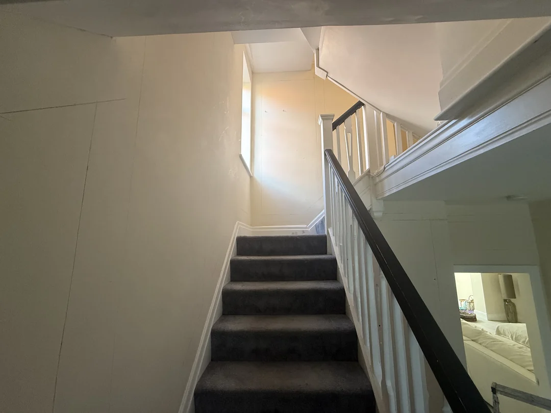 The plain stairwell walls before fitting the decorative beading.