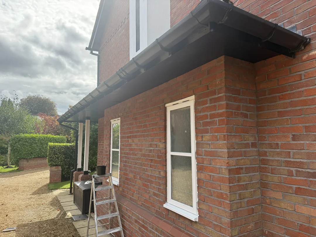 A closer view of the white window surround and dark eaves.
