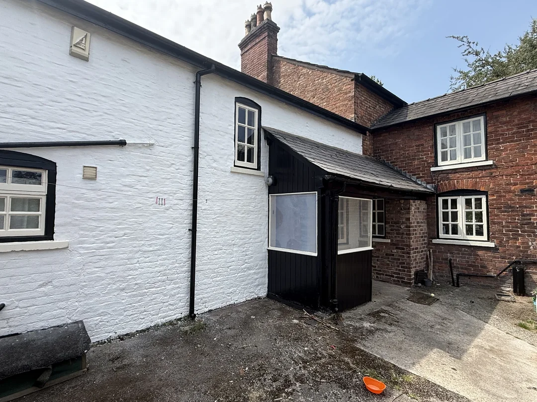 The decorated courtyard elevation, with white painted masonry and contrasting black details.
