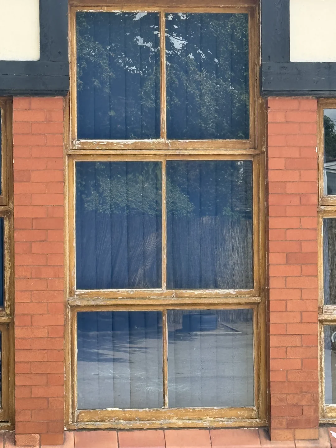Before decoration: a tall timber window.