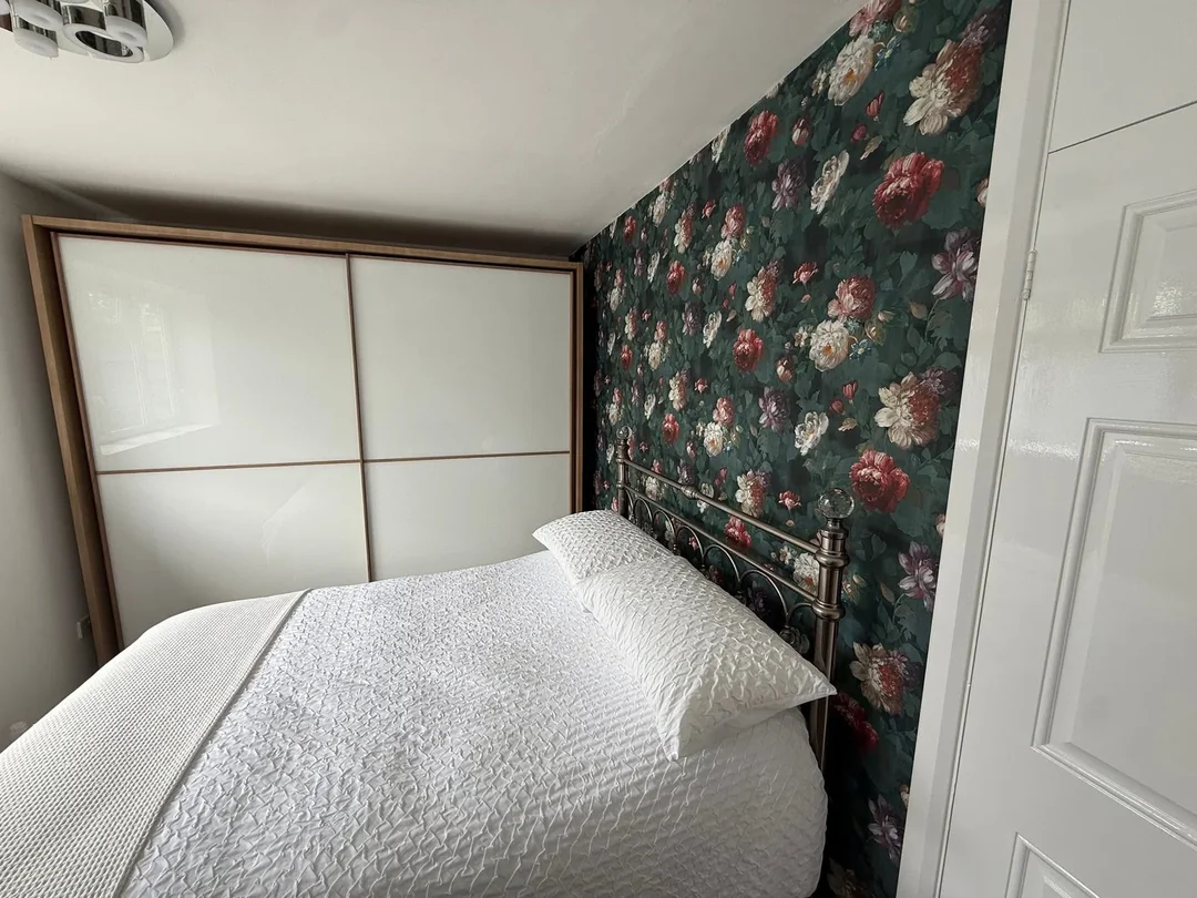 The completed floral wallpaper feature wall.