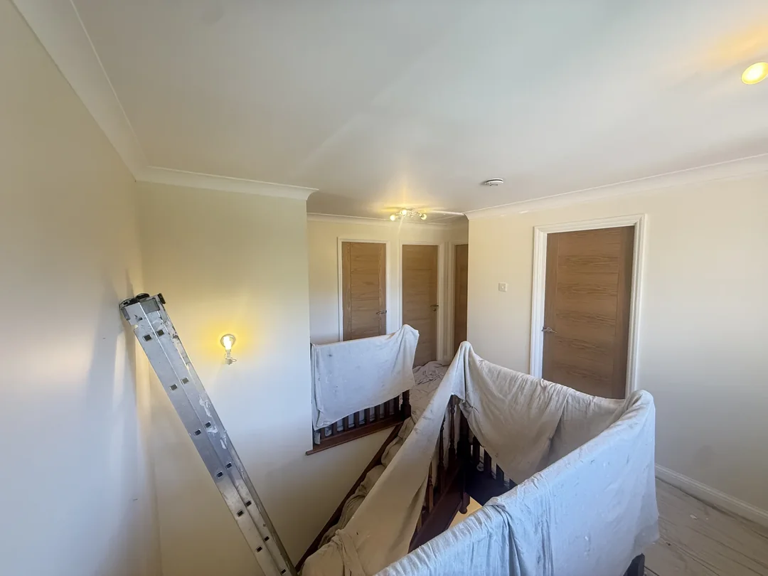 Work in progress on the landing, with the balustrade protected.