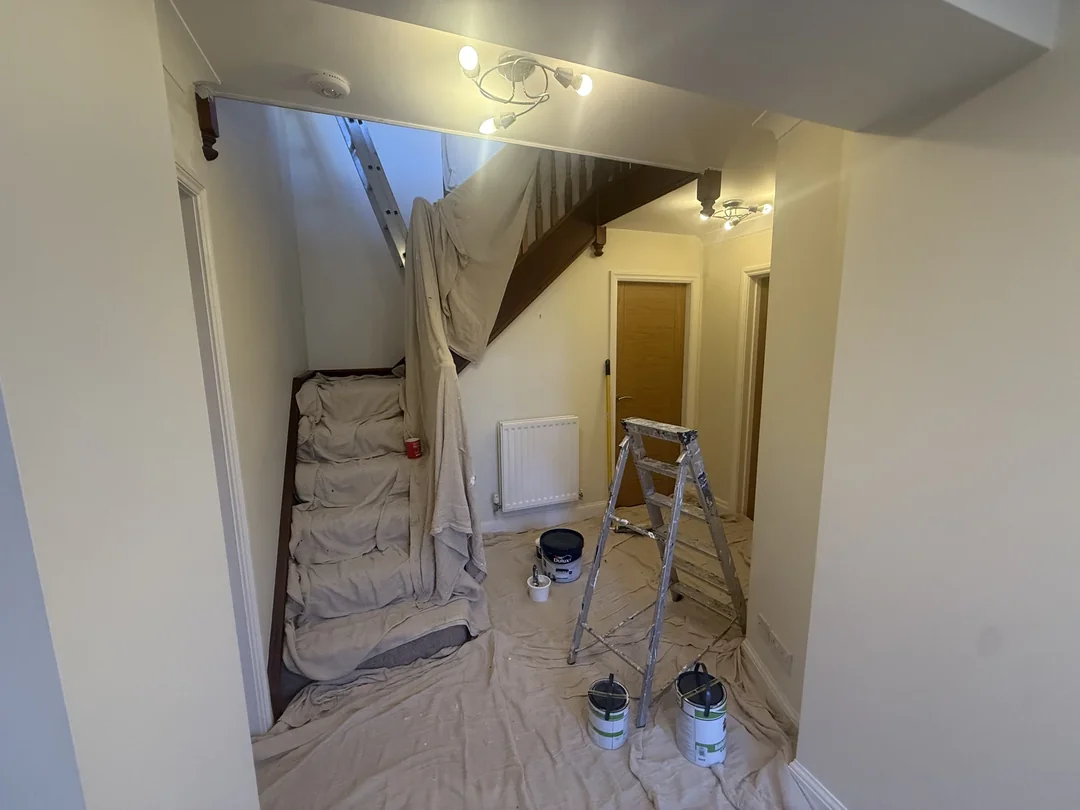 The stairs and hall covered during decorating.