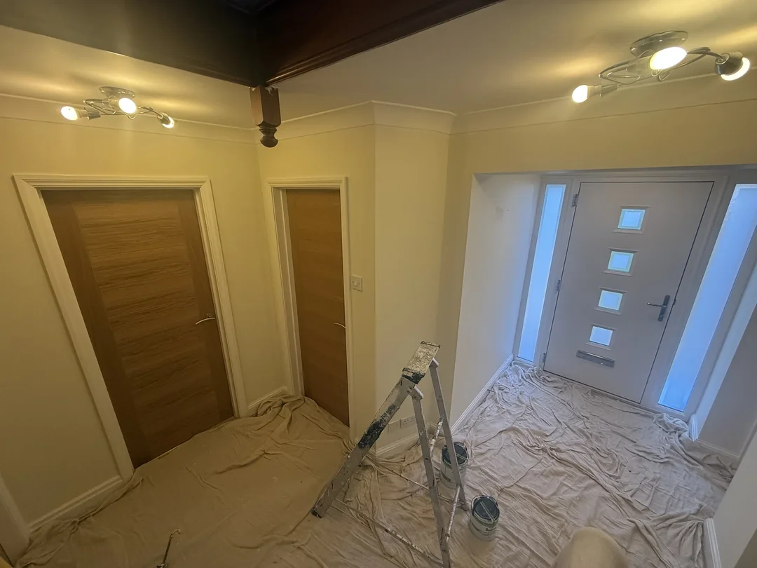 Hallway decorating in progress around the retained doors.