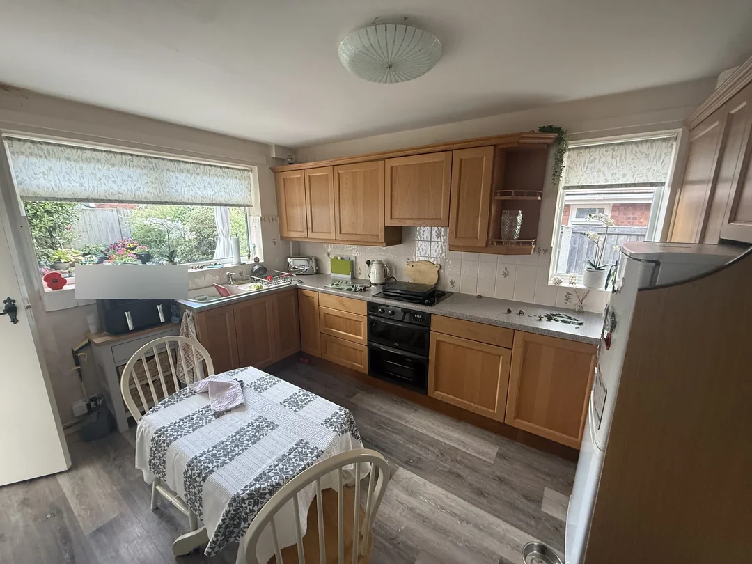 Before: the kitchen with its original timber-coloured cabinet fronts.