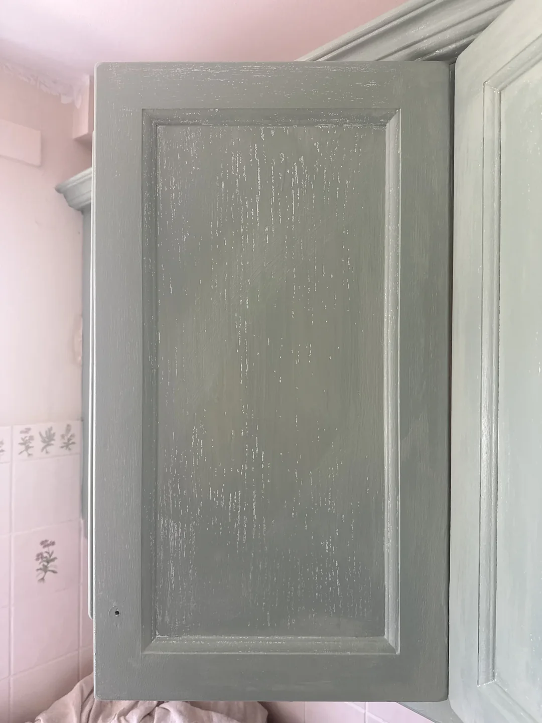 During preparation: a cabinet door being worked on before the final finish.