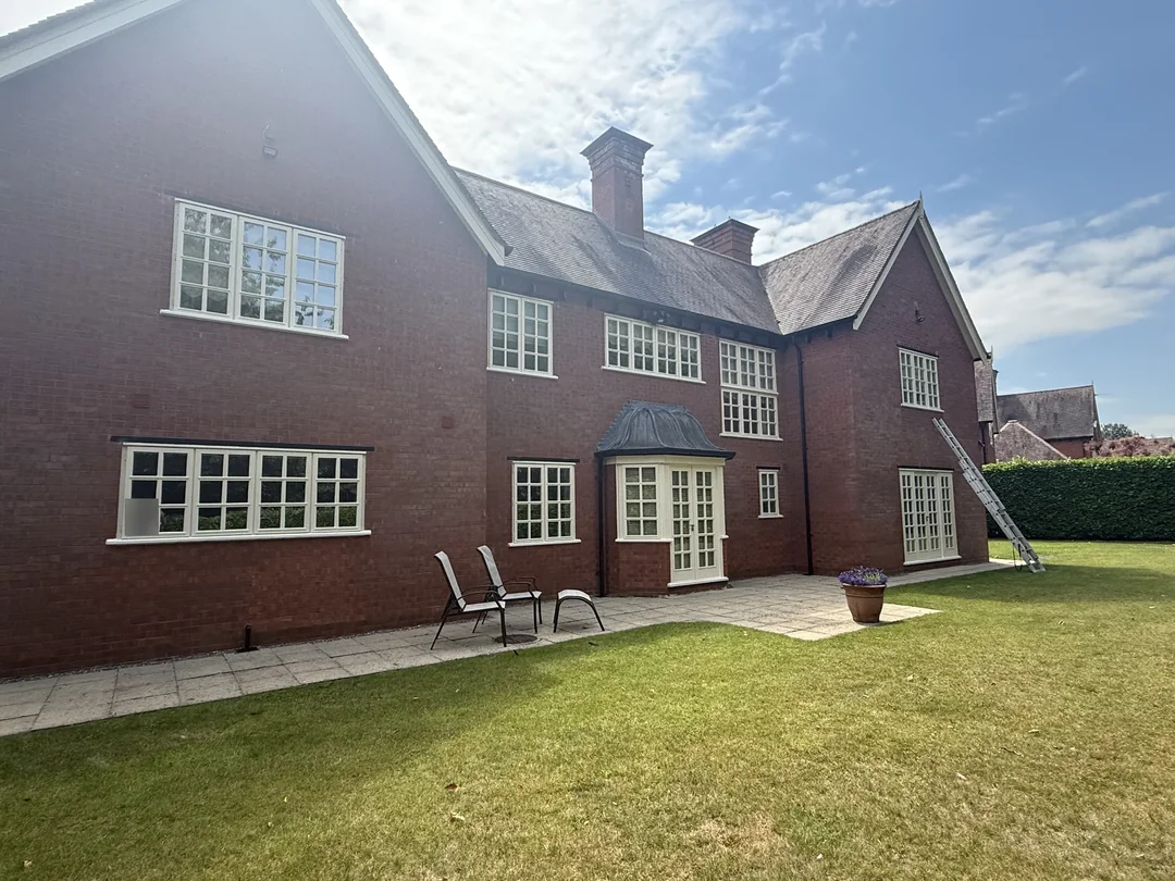 The rear elevation, with white window frames and contrasting brickwork.