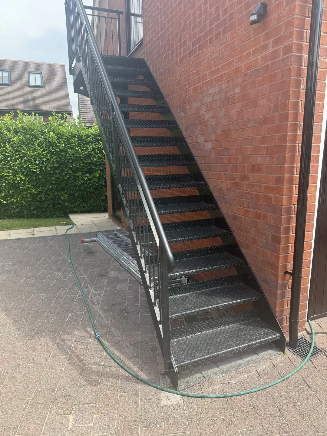 The metal staircase at an earlier stage of the repaint.