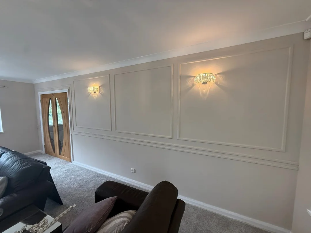 The panel pattern continues onto the adjoining living-room wall.