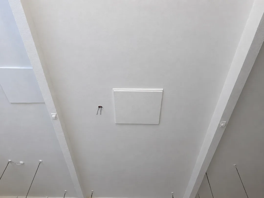 Completed white ceiling around the access panel at Stapeley Broad Lane school, Nantwich