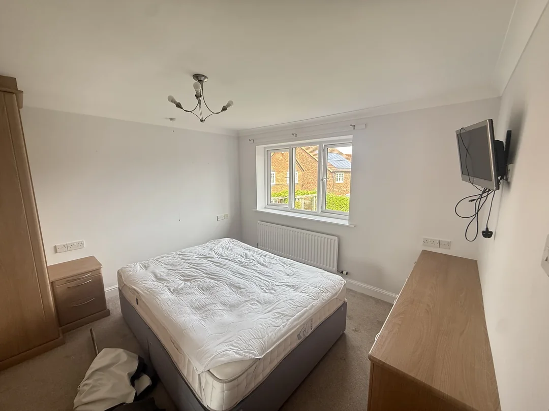 Light painted walls around the bedroom window and existing furniture.